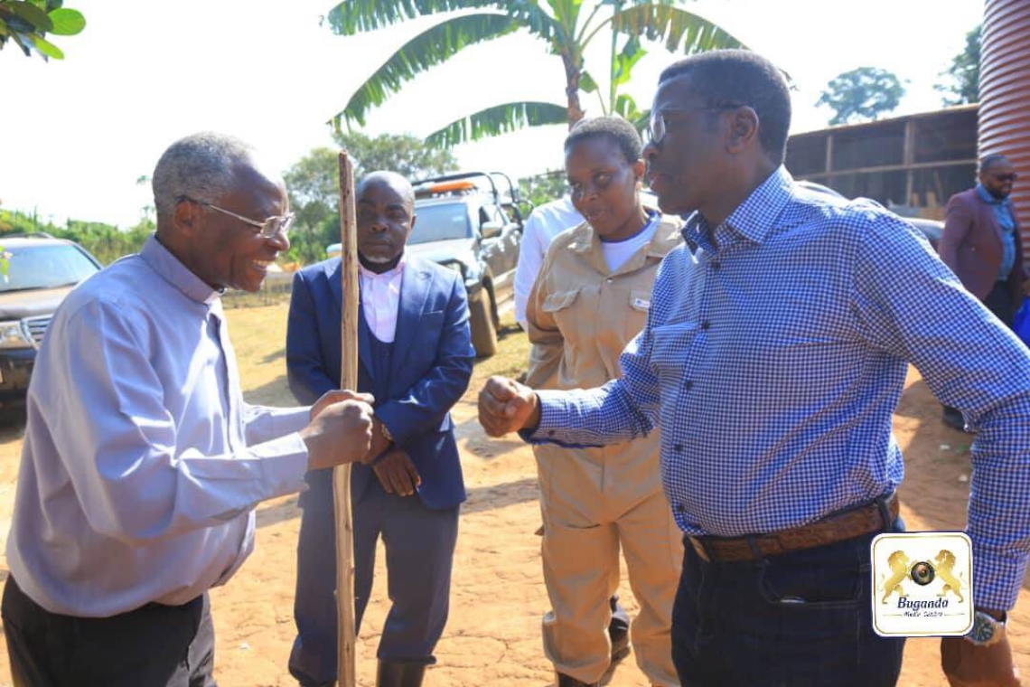 Katikkiro Mayiga (right) arrives at the farm of Mr. Anthony Mateega (left)